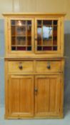 A Victorian pine dresser cabinet with coloured glass panelled top above cupboard section on plinth