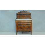 A 19th century Continental flame mahogany marble topped chiffonier with carved back above two