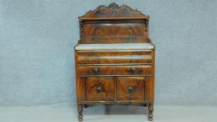 A 19th century Continental flame mahogany marble topped chiffonier with carved back above two