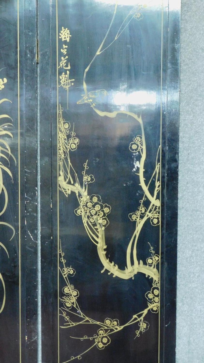 A Japanese black lacquered three fold and four panel screen with mother of pearl and bone inlay. - Image 18 of 23