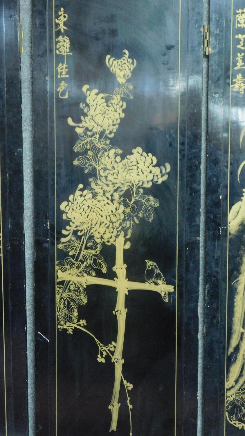 A Japanese black lacquered three fold and four panel screen with mother of pearl and bone inlay. - Image 16 of 23