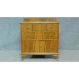 A mid 20th century figured walnut chest of two drawers above a pair of panel doors. H.100 W.92 D.