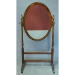 An early 20th century Regency style mahogany cheval mirror on swept stretchered supports. H.137cm