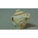A carved vintage soapstone elephant teapot with baby elephant form finial. H.18cm
