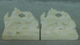 A pair of vintage carved white stone Oriental style book ends in the form of a bear and a goat. H.11