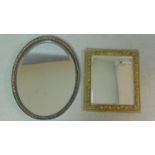 A gilt framed wall mirror and an oval framed mirror. 56x45cm