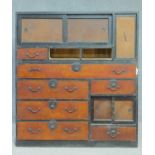 A Japanese Sendai-Tansu two section kimono chest with an arrangement of eleven drawers and panel