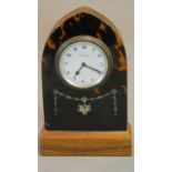 A tortoiseshell cased lancet shaped mantel clock with white metal swag inlay. Swiss made movement.