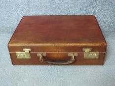 A vintage tan hide Harrods documents attaché case. With a pale suede interior and expanding