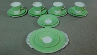 A set of four Art Deco Royal Albert tea cups and saucers with sandwich plate to match.