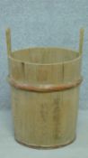 A 20th century double handled wooden rice bucket with written Oriental characters. H.62cm