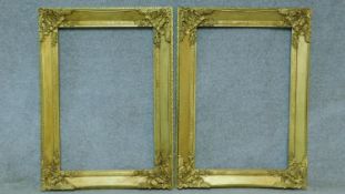 A pair of floral decorated giltwood and gesso picture or mirror frames. 115x84cm