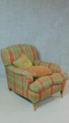 A Howard style armchair on turned tapering supports in tartan upholstery. H.86cm