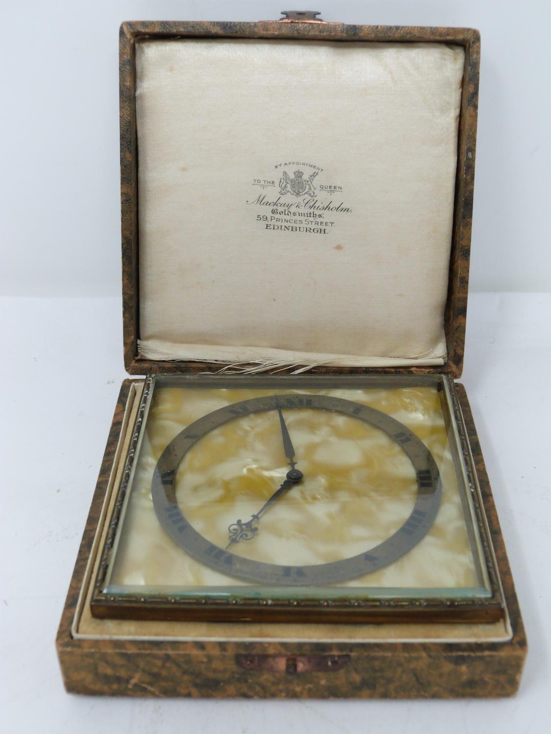 An Art Deco gilded bronze cased desk clock by Mackay & Chisholm. In its original fitted box with