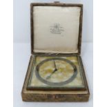 An Art Deco gilded bronze cased desk clock by Mackay & Chisholm. In its original fitted box with