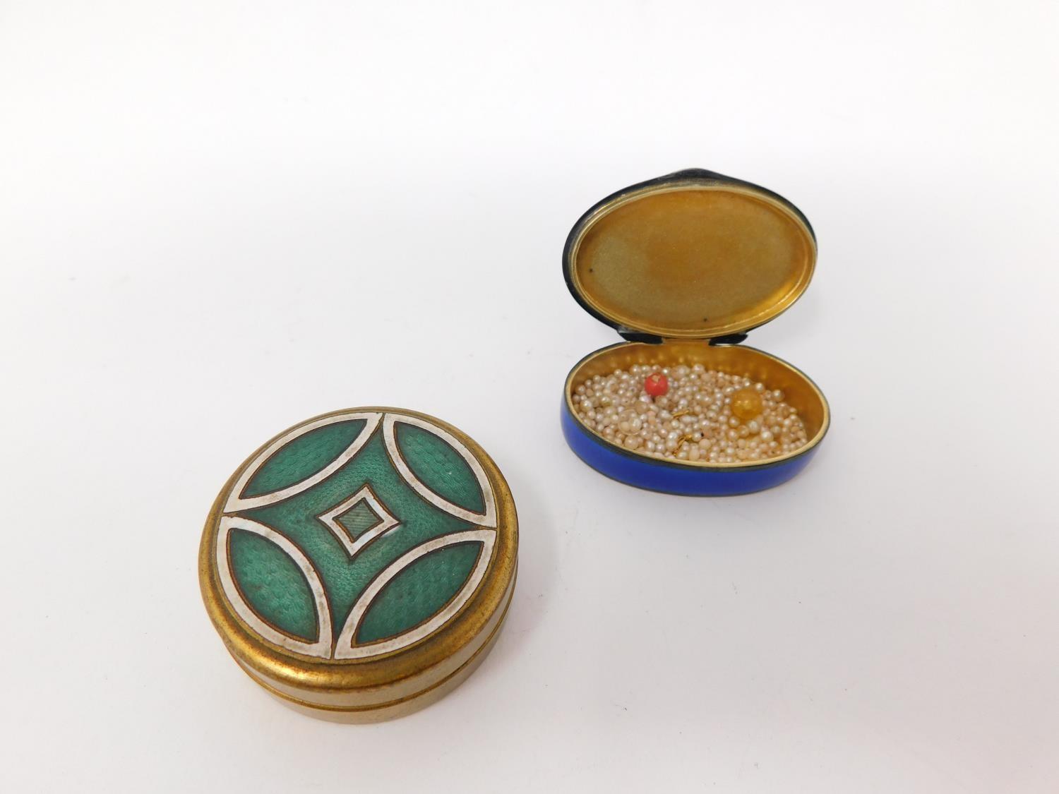 Two enamel boxes. One Continental silver royal blue guilloche enamel pill box with garland and