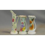 Three vintage hand painted Radford Pottery jugs. Two with swan form handles, scalloped rims and bold