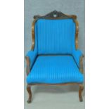 A late 19th century carved mahogany armchair in vibrant blue fabric painted upholstery on cabriole