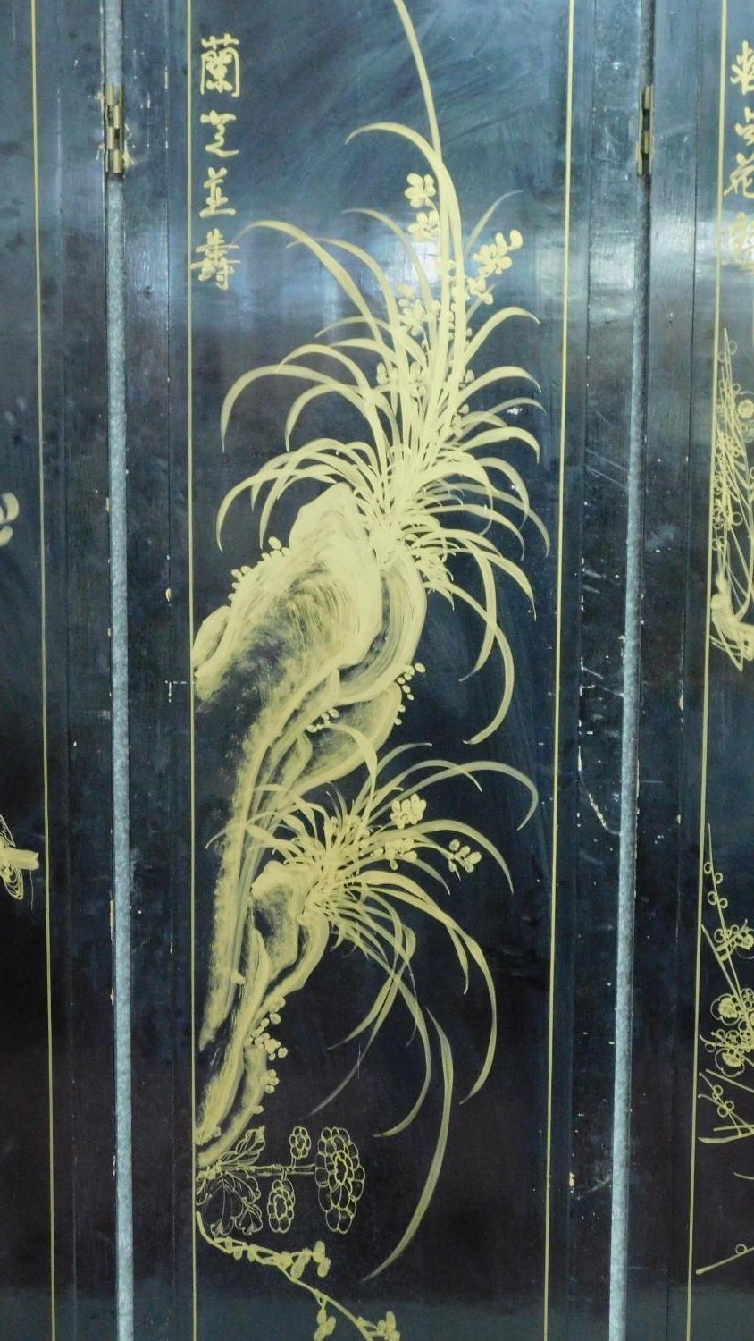 A Japanese black lacquered three fold and four panel screen with mother of pearl and bone inlay. - Image 17 of 23