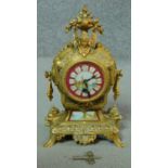 A French style brass cased mantel clock with painted face. (with pendulum and key). H.29cm