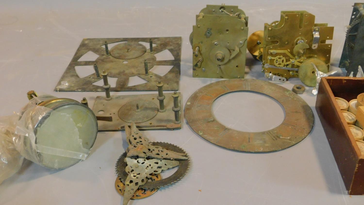 A collection of antique clock parts including clock movements, various clock dials and faces, a - Image 2 of 7