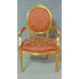 A gilt framed fauteuil in the Louis XVl style in floral rouge upholstery. H.104cm