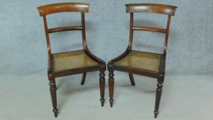 A pair of 19th century rosewood dining chairs with cane seats on turned tapering supports. H.84cm