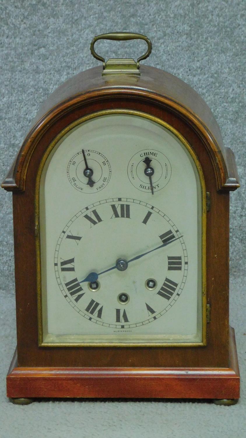 An antique Wurtemburg Westminster chime mahogany cased bracket clock. With brass carrying handle and