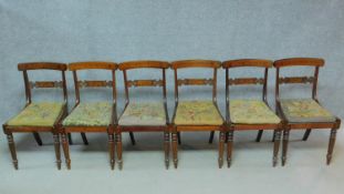 A set of six George IV faux rosewood and satinwood inlaid bar back dining chairs with drop in