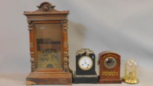 A carved oak wall clock case painted with a gilt design of a hummingbird on a branch, a glass dome