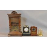 A carved oak wall clock case painted with a gilt design of a hummingbird on a branch, a glass dome