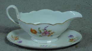 A Hutschenreuther, LHS porcelain gravy boat on stand with hand painted floral design. Makers stamp