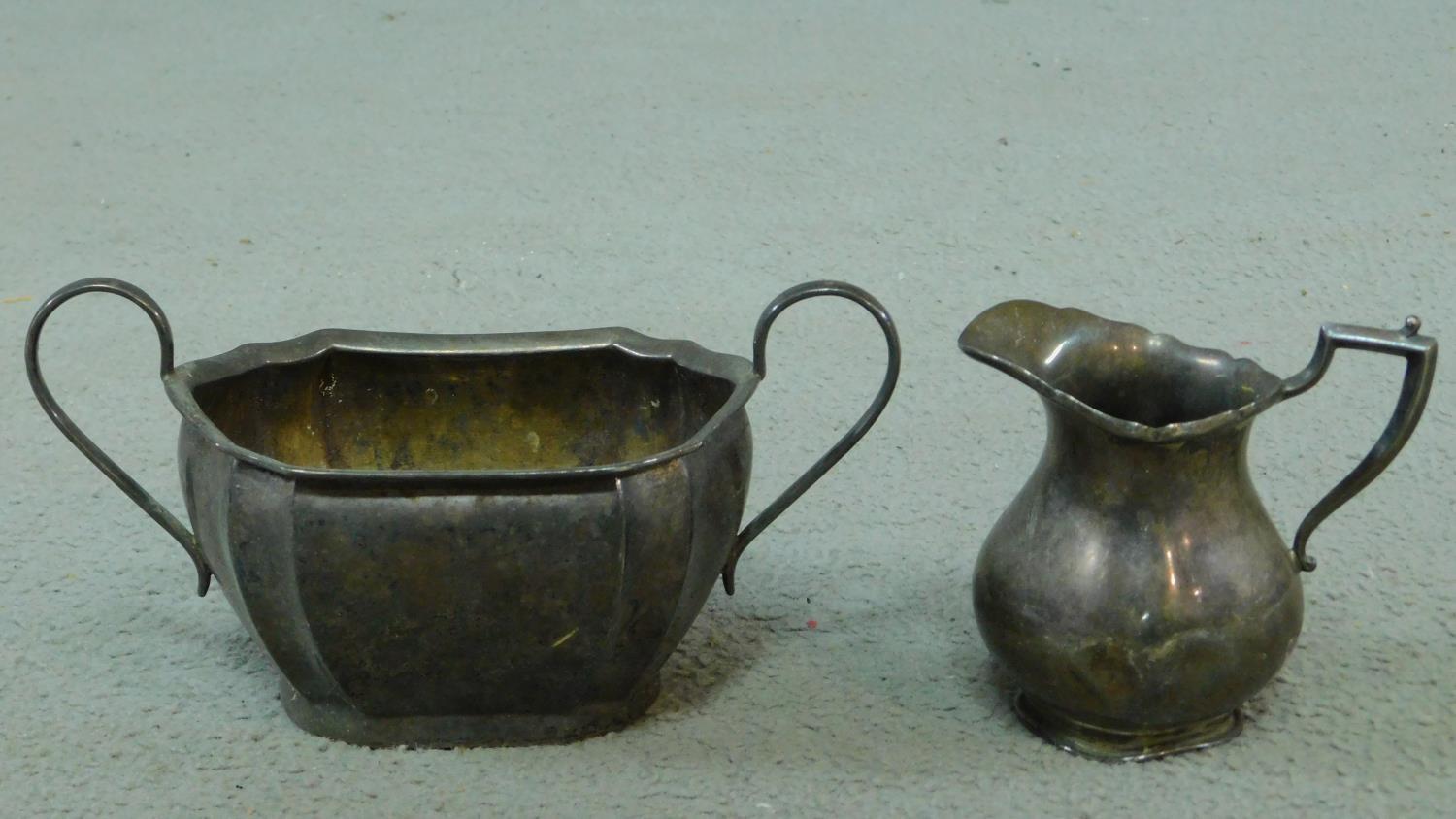 Two sterling silver items including an Edwardian milk jug with fluted rim and linear design