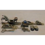 A collection of antique and vintage woodworking planes including a Record plane, a Stanley plane and