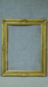 A floral decorated giltwood and gesso picture or mirror frame. 100x125cm
