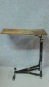 A 20th century overbed table on metal supports. H.71 W.66 D.35cm
