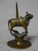 An antique Indian brass figure of the Hindu bull god Nandi. 18th-19th century. H.15 W.9cm