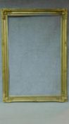 A large full height floral decorated giltwood and gesso picture or mirror frame. 210x150cm