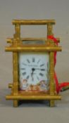 An antique gilt carriage clock, with enamel painted panels with cherubs catching butterflies.