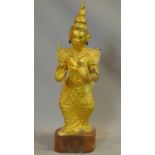 An early 20th century South East Asian lacquered carved gilt wood statue. Inlaid with coloured