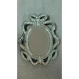 A Venetian style wall mirror with glazed scrolling ribbon borders. 46x36cm