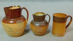 A collection of antique Doulton Lambeth stoneware. Including two stoneware glazed harvest jugs