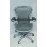 A contemporary Herman Miller Aeron ergonomic design office chair with reclining, swivelling and up