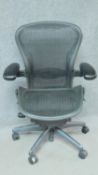 A contemporary Herman Miller Aeron ergonomic design office chair with reclining, swivelling and up