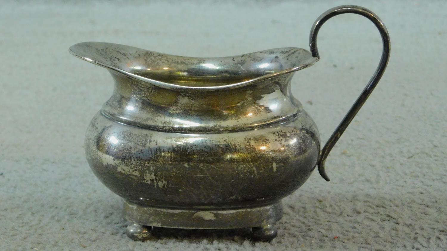 Three sterling silver items. Including an Art Deco milk jug on four button feet, hallmarked: EV - Image 6 of 11
