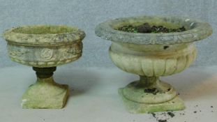 A reconstituted stone Regency style garden urn and another similar. H.47cm (damage to both).