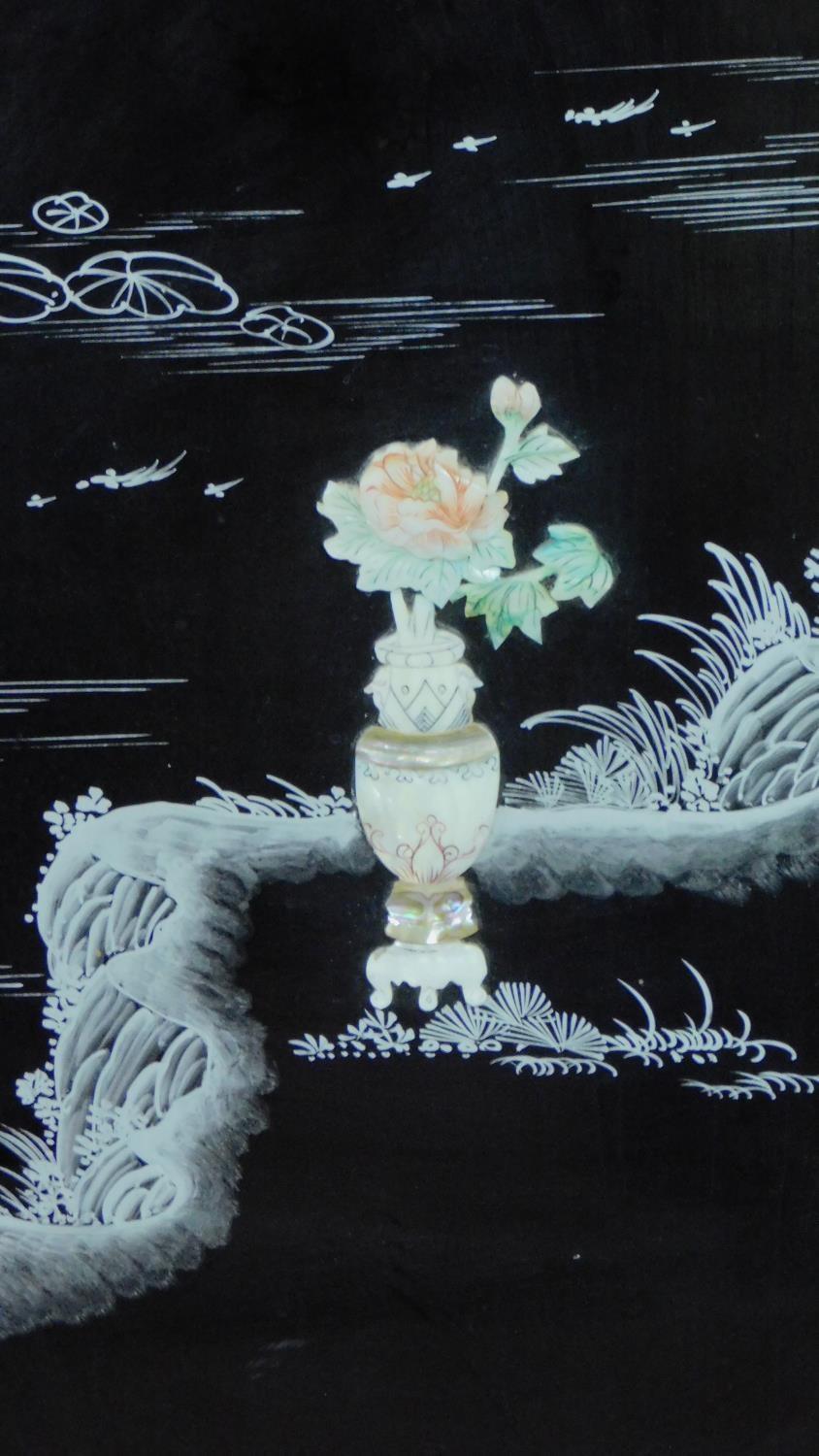 A Japanese black lacquered three fold and four panel screen with mother of pearl and bone inlay. - Image 5 of 23