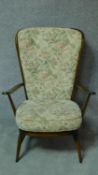 A vintage Ercol beech framed Windsor high back armchair with fauna & flora design fabric upholstered