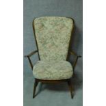 A vintage Ercol beech framed Windsor high back armchair with fauna & flora design fabric upholstered