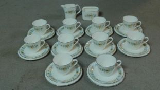 A Royal Doulton fine bone china part tea service 'Pastorale' pattern with delicate floral design.